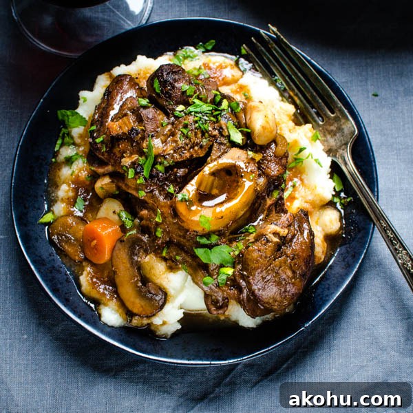 A serving of braised veal over mashed potatoes.