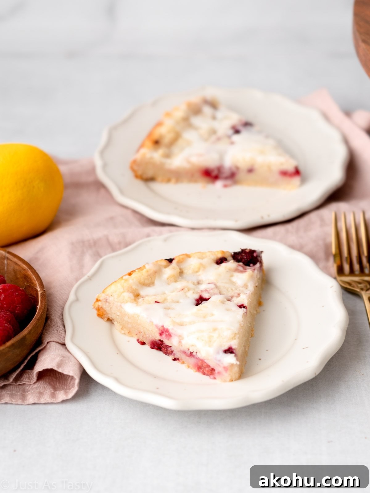 Lemon-Glazed Raspberry Ricotta Cake: Moist Italian Dessert 3 Slice of raspberry ricotta cake on a plate.