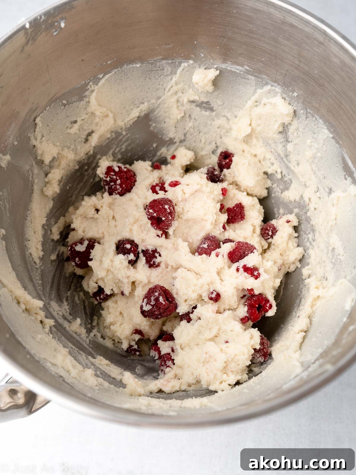 Lemon-Glazed Raspberry Ricotta Cake: Moist Italian Dessert 8 Cake batter with raspberries in a bowl.