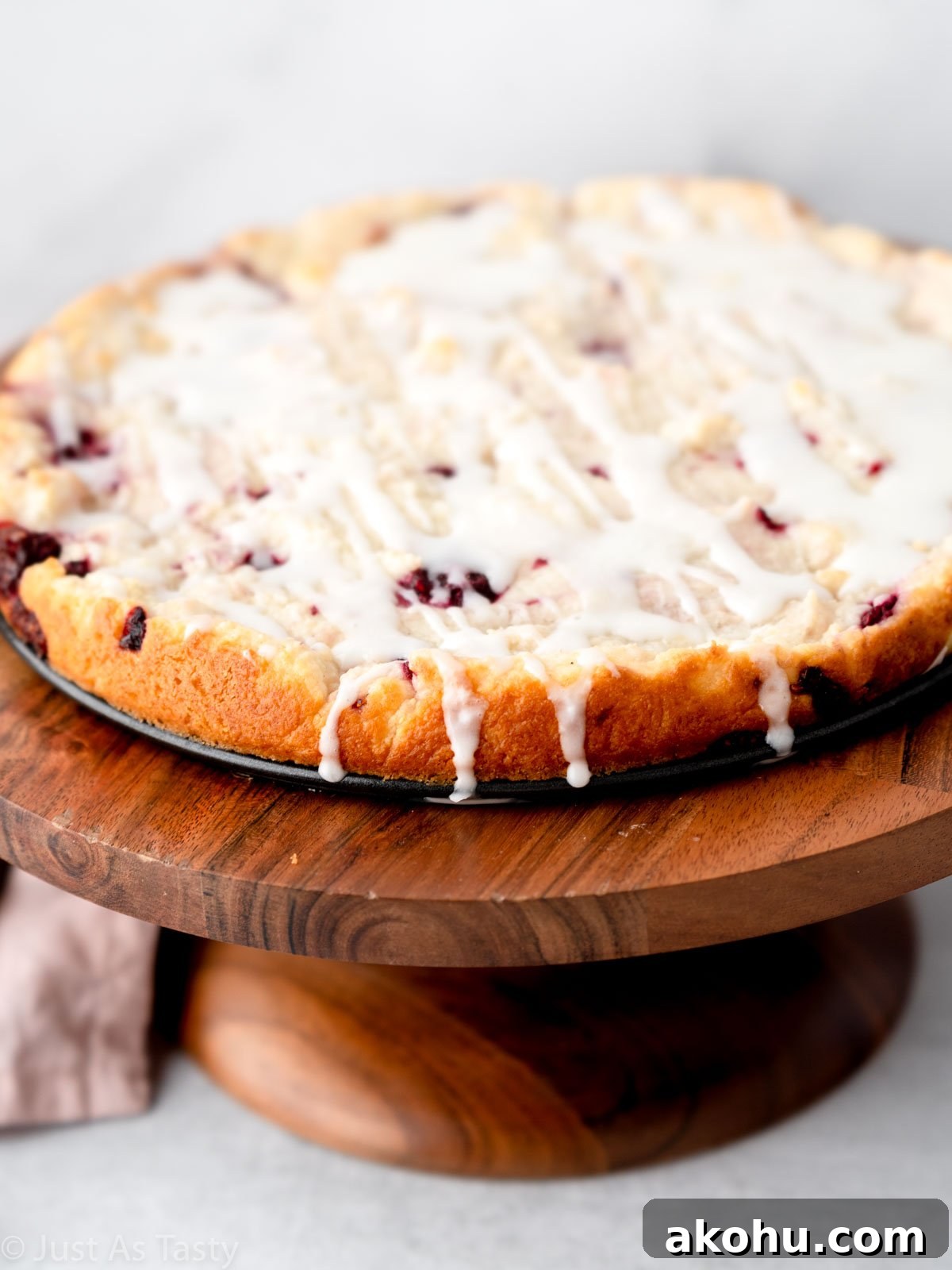 Lemon-Glazed Raspberry Ricotta Cake: Moist Italian Dessert 9 Close-up of glazed raspberry ricotta cake on a stand.