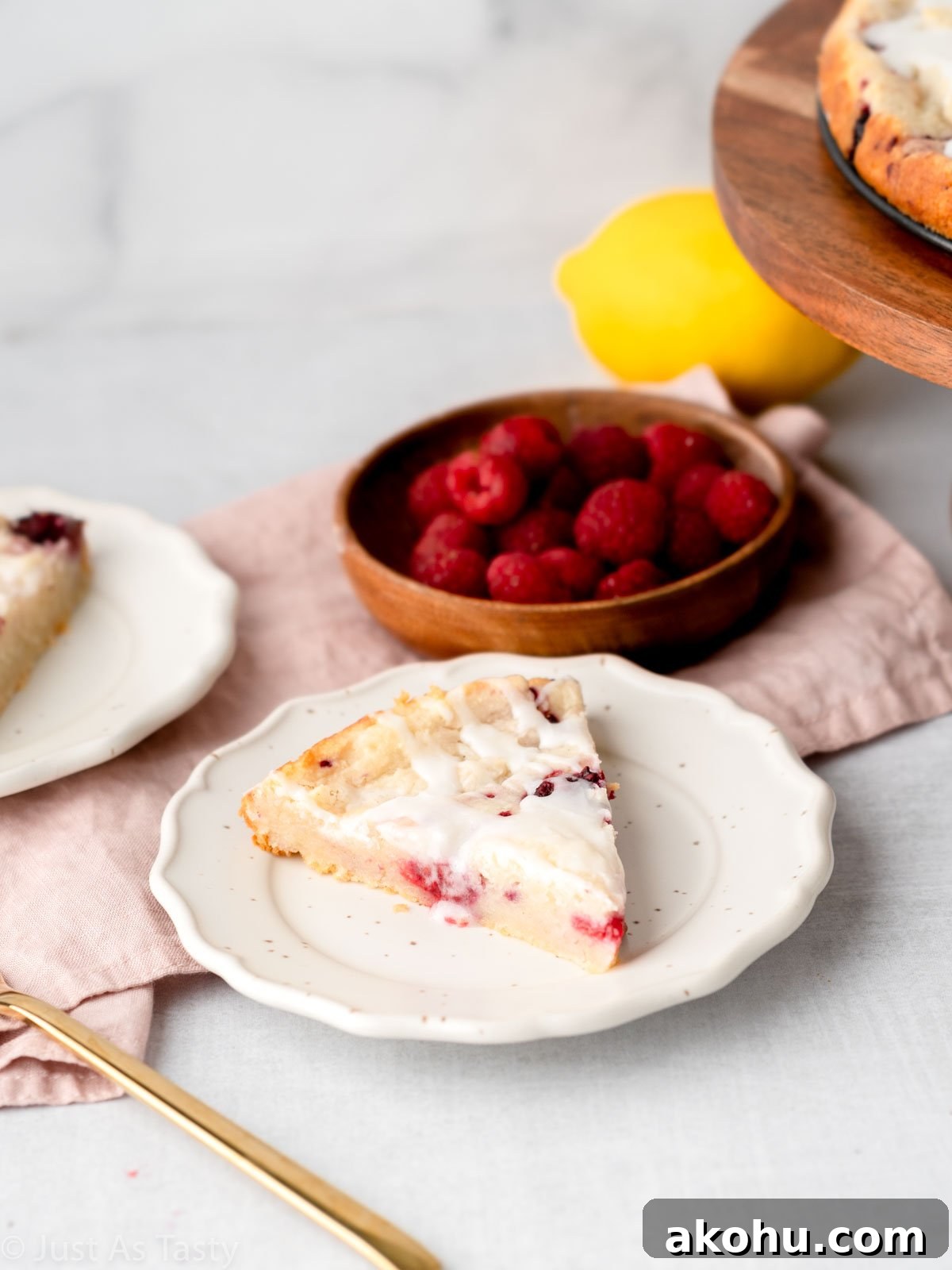 Lemon-Glazed Raspberry Ricotta Cake: Moist Italian Dessert 10 Slice of raspberry ricotta cake on a plate.