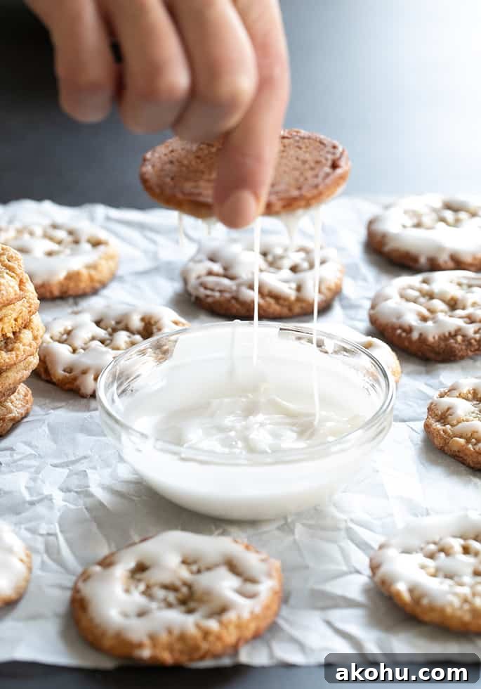 Thin Chewy Gluten-Free Iced Oatmeal Cookies 3 Icing dripping off of gluten free iced oatmeal cookies