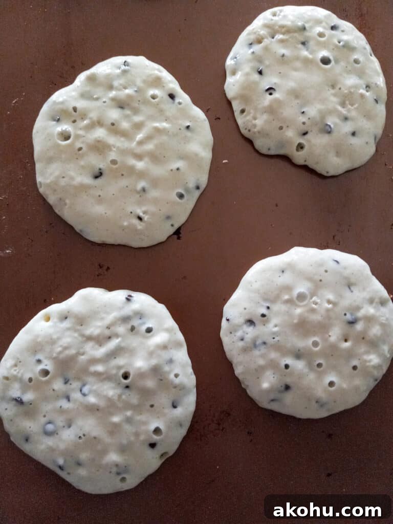 pancakes cooking on the griddle