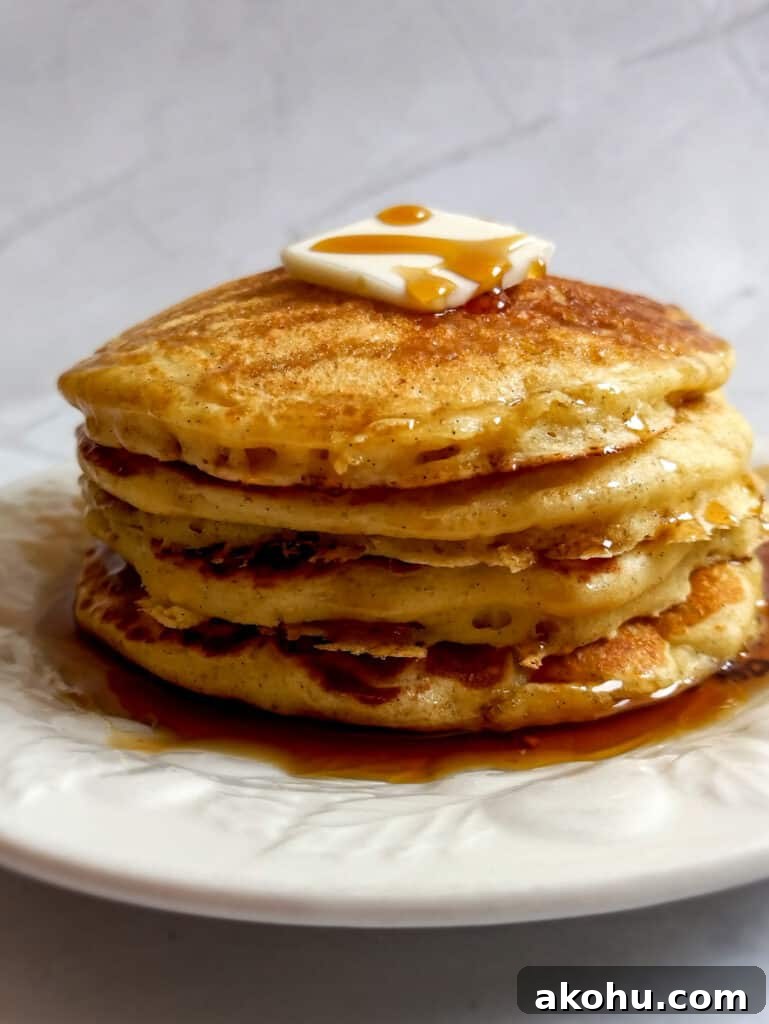 stack of buttermilk pancakes with butter and syrup