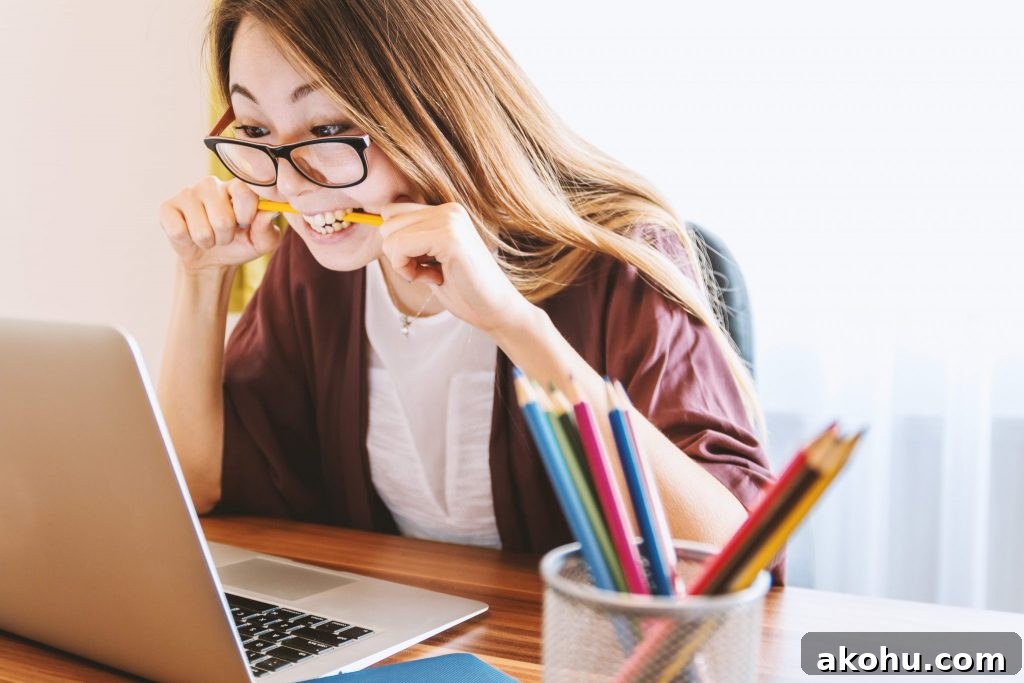 woman at computer biting pencil for genealogy mistake