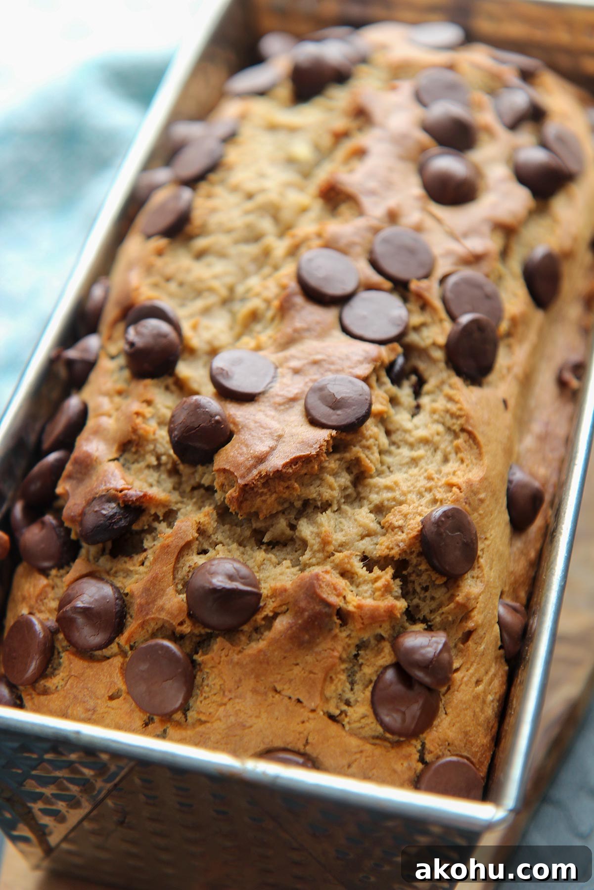 Moist Banana Bread with Chocolate Chips: Classic Recipe 5 baked banana bread with chocolate chips on top in a loaf pan.