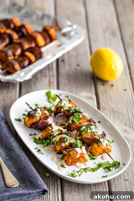 BBQ paprika sweet potato skewers with a lemon tahini sauce make a fantastic vegetarian and vegan BBQ grilled side dish to serve up this summer or can go with meat, fish and cheese really well. Using just sweet potato, and red onion coated in warming paprika, plus a sauce of tahini, lemon juice and gentle cinnamon, topped with coriander, these skewers are sure to make everyone around the lunch or dinner table happy!