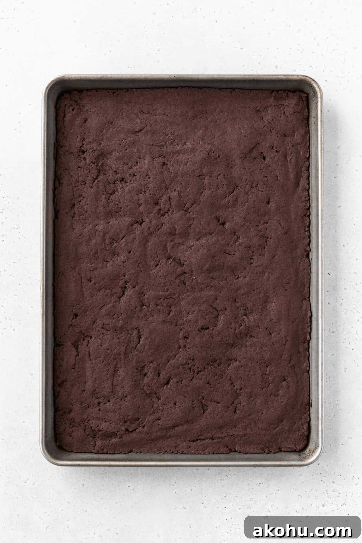 Gluten-Free Ice Cream Sandwiches You’ll Love 9 Baked chocolate ice cream sandwich cooking on a baking sheet.