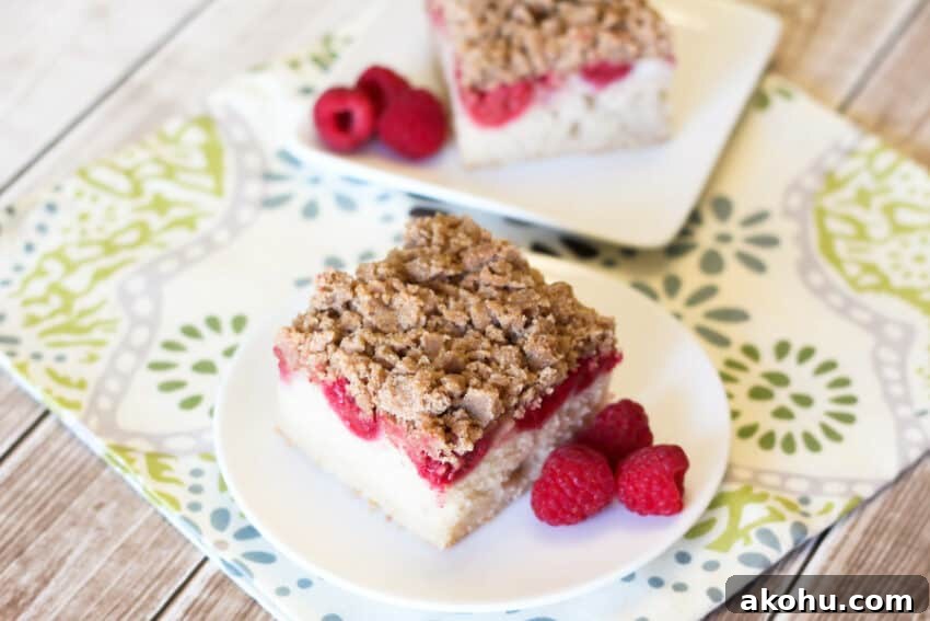 raspberry vegan coffee cake slice with berries on plate