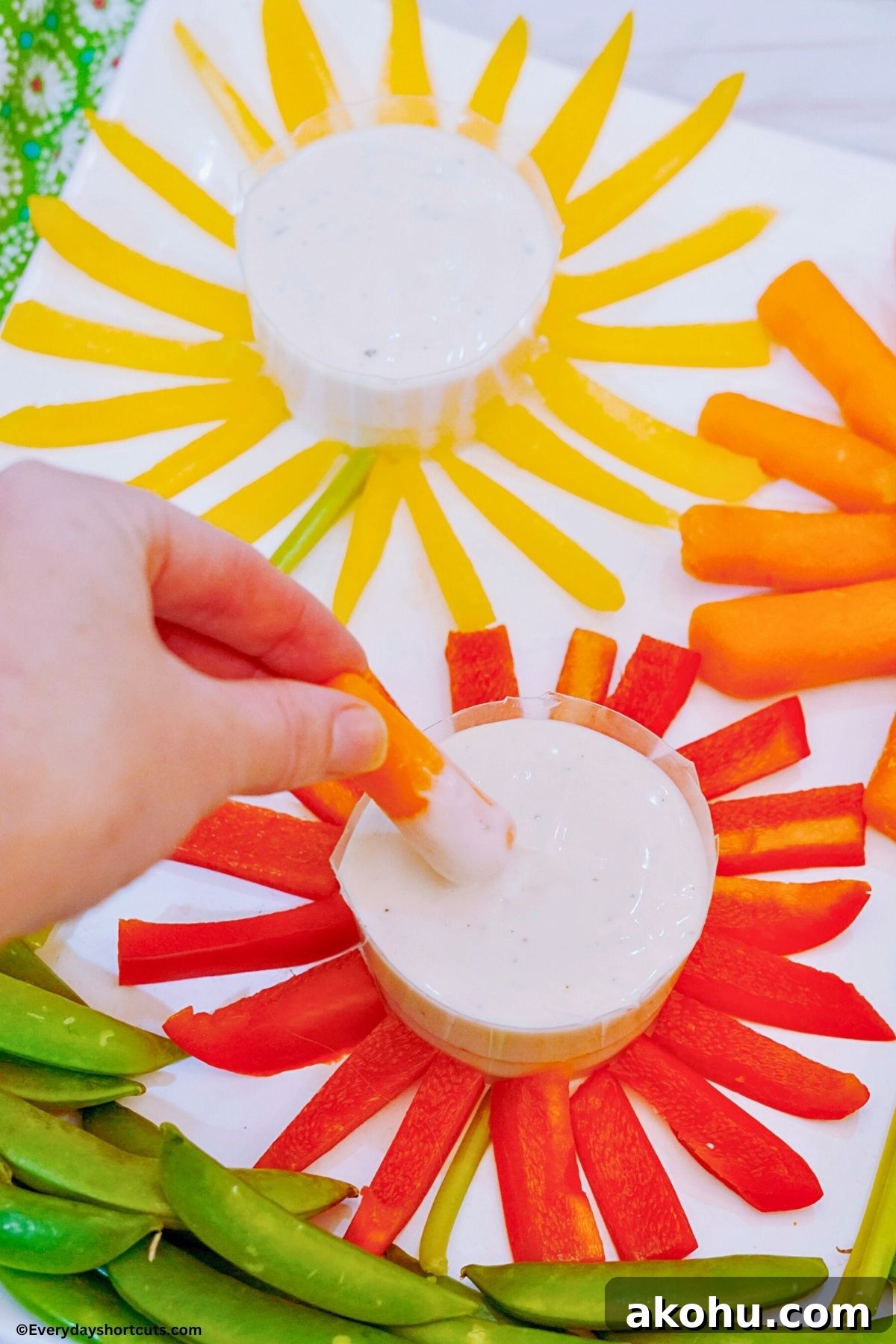 Blooming Vegetable Platter: Stunning Veggie Flower Tray Tutorial 3 dipping a carrot into a bowl or ranch dip