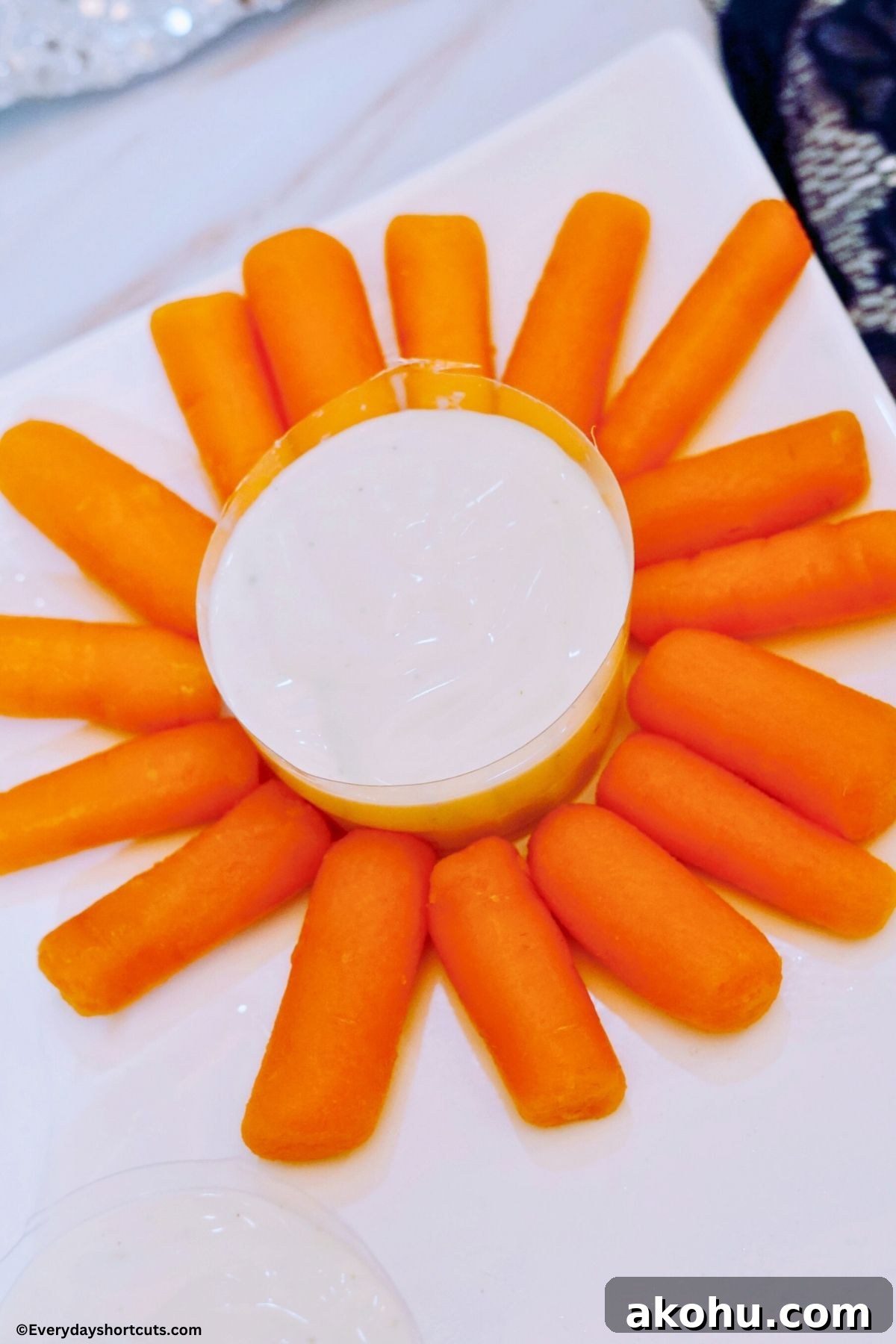 Blooming Vegetable Platter: Stunning Veggie Flower Tray Tutorial 5 baby carrots in a circular pattern with a bowl of ranch dressing in the middle of it