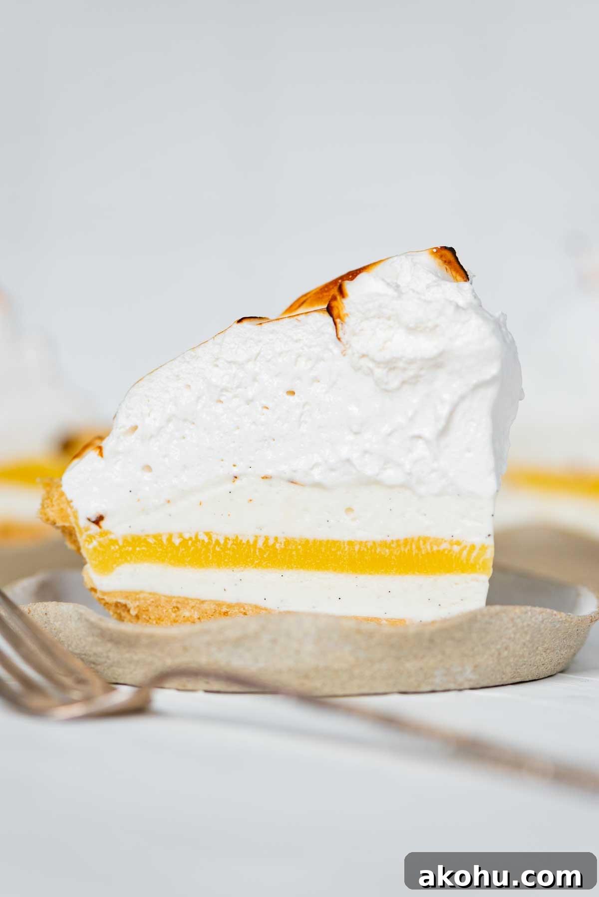 Slices of lemon meringue ice cream pie on dessert plates | © Beyond the Butter®