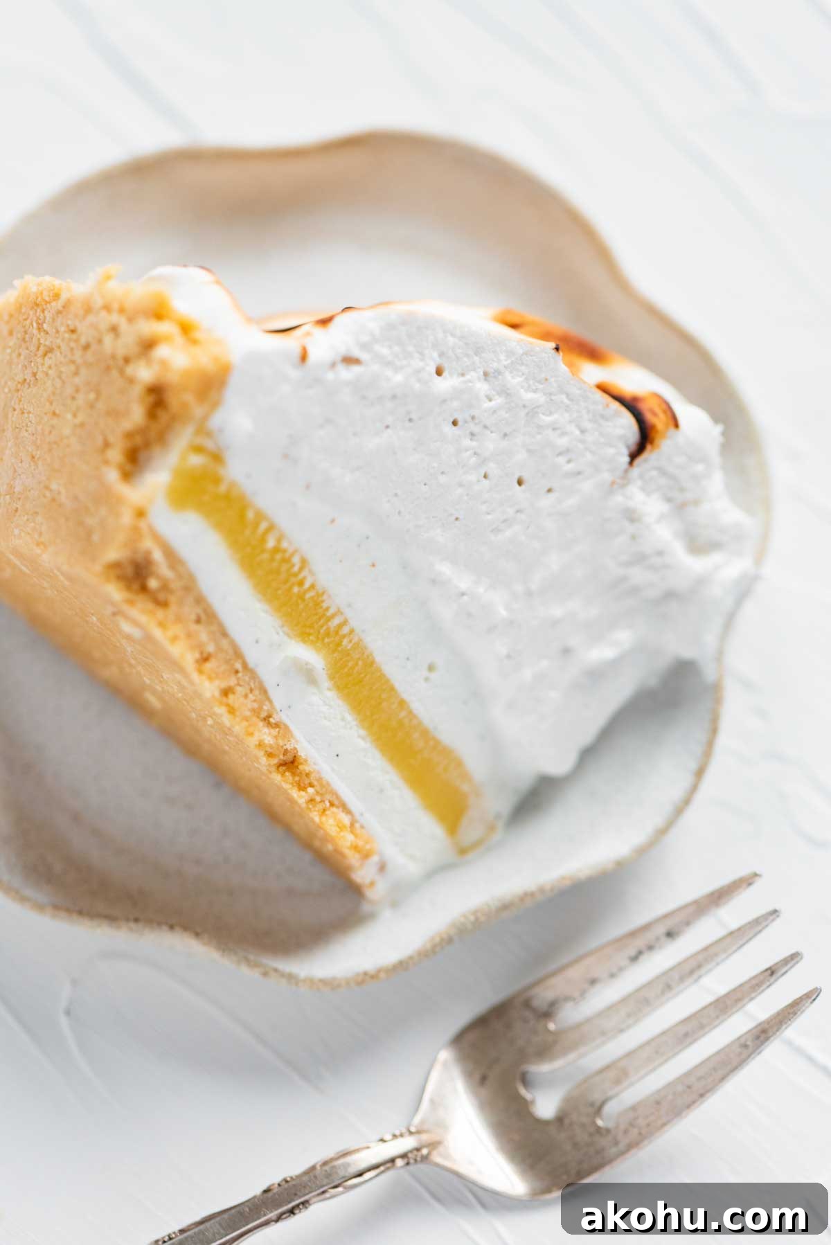 Slice of lemon meringue ice cream pie on its side | © Beyond the Butter®