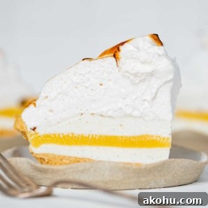Slices of lemon meringue ice cream pie on dessert plates.