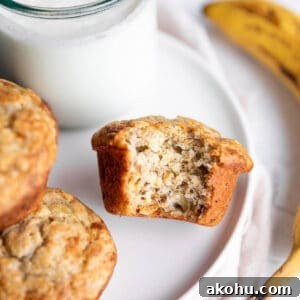 Sourdough Banana Muffins with Cinnamon Streusel 12 A plate with banana muffins and a glass of milk with a banana.
