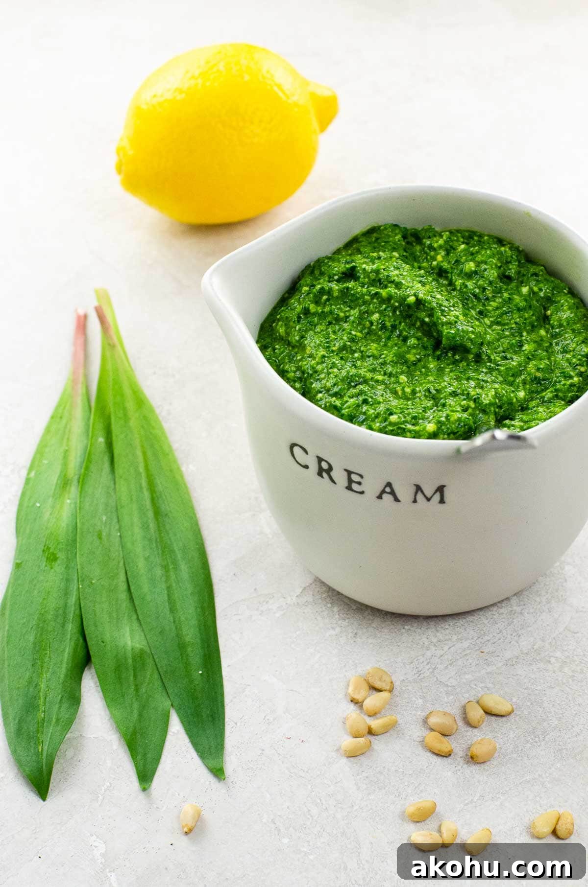 Ramp Pesto with Fresh Basil and Spinach: Spring Garlic Sauce 2 ramp pesto in a small pitcher with ramp leaves, a lemon, and pine nuts