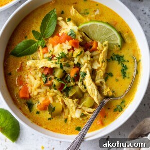 chicken curry soup in a bowl with a spoon