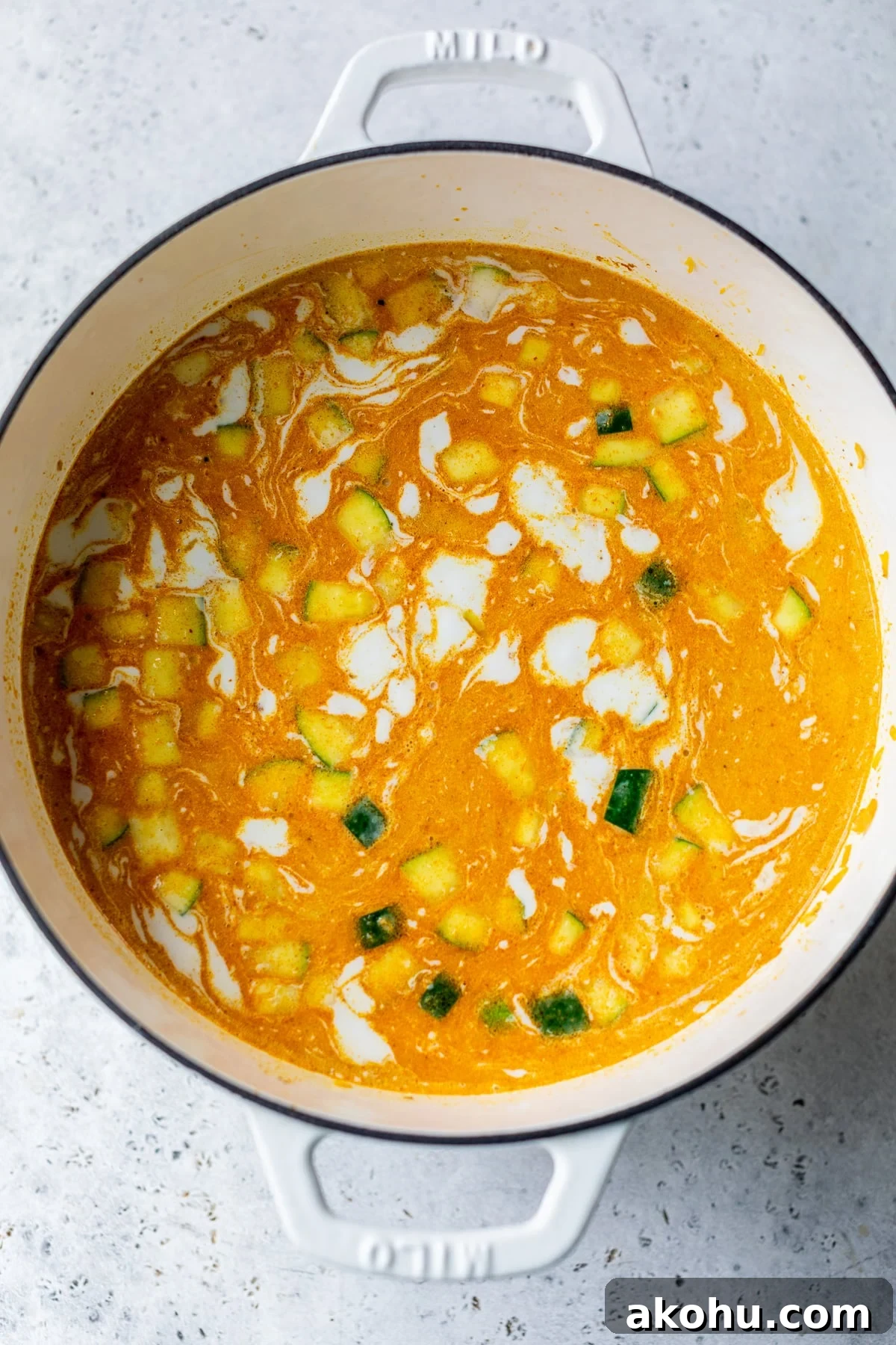 coconut milk added to the soup in a dutch oven