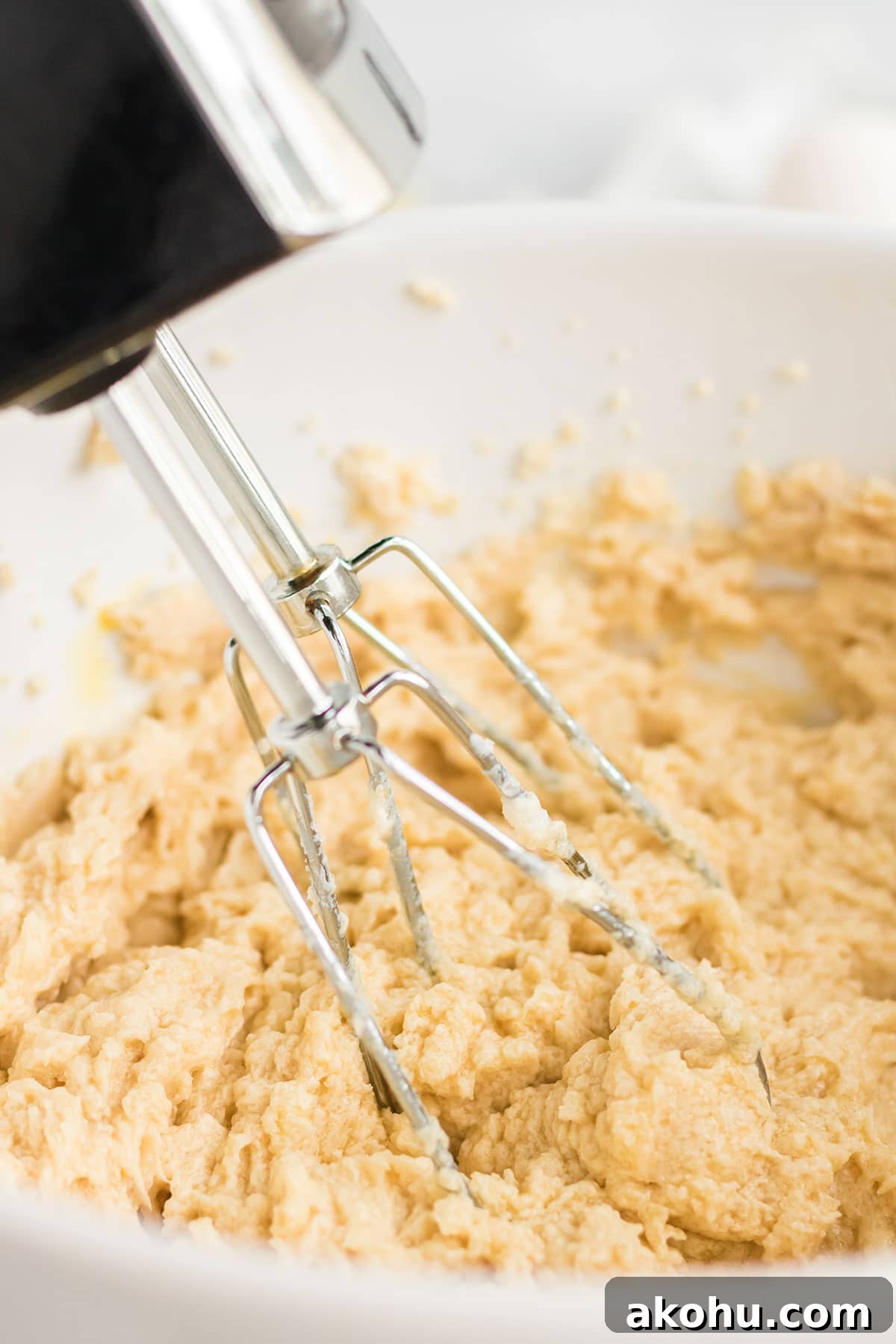 Mixing the batter with an electric mixer.
