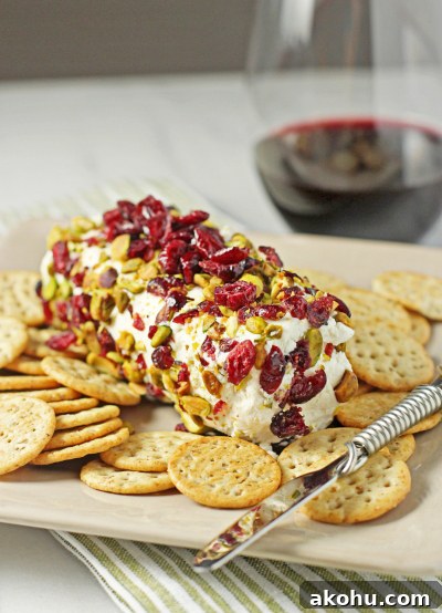 Baked Goat Cheese on a platter with crackers and a cheese knife.