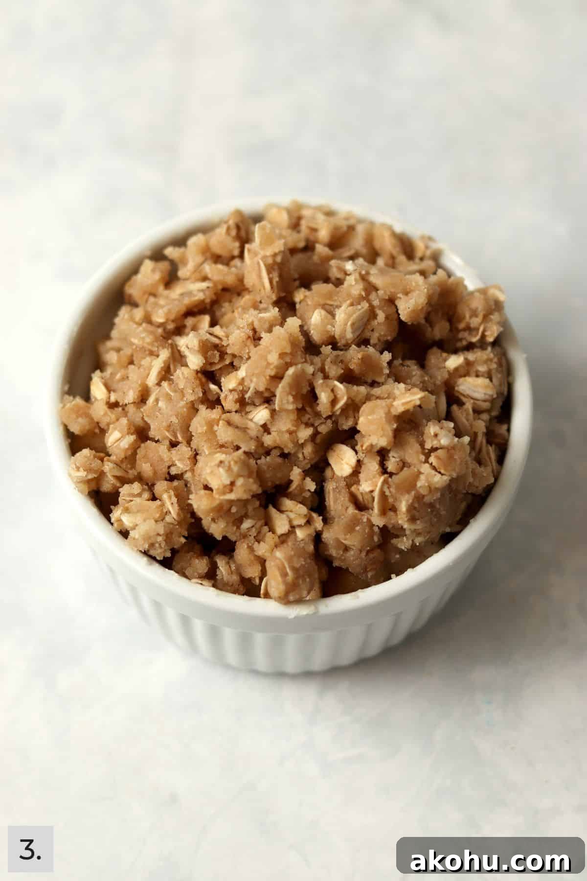 Individual Apple Crisp with Oat Topping — Single-Serve Recipe 6 An unbaked single serve apple crisp in a ramekin.