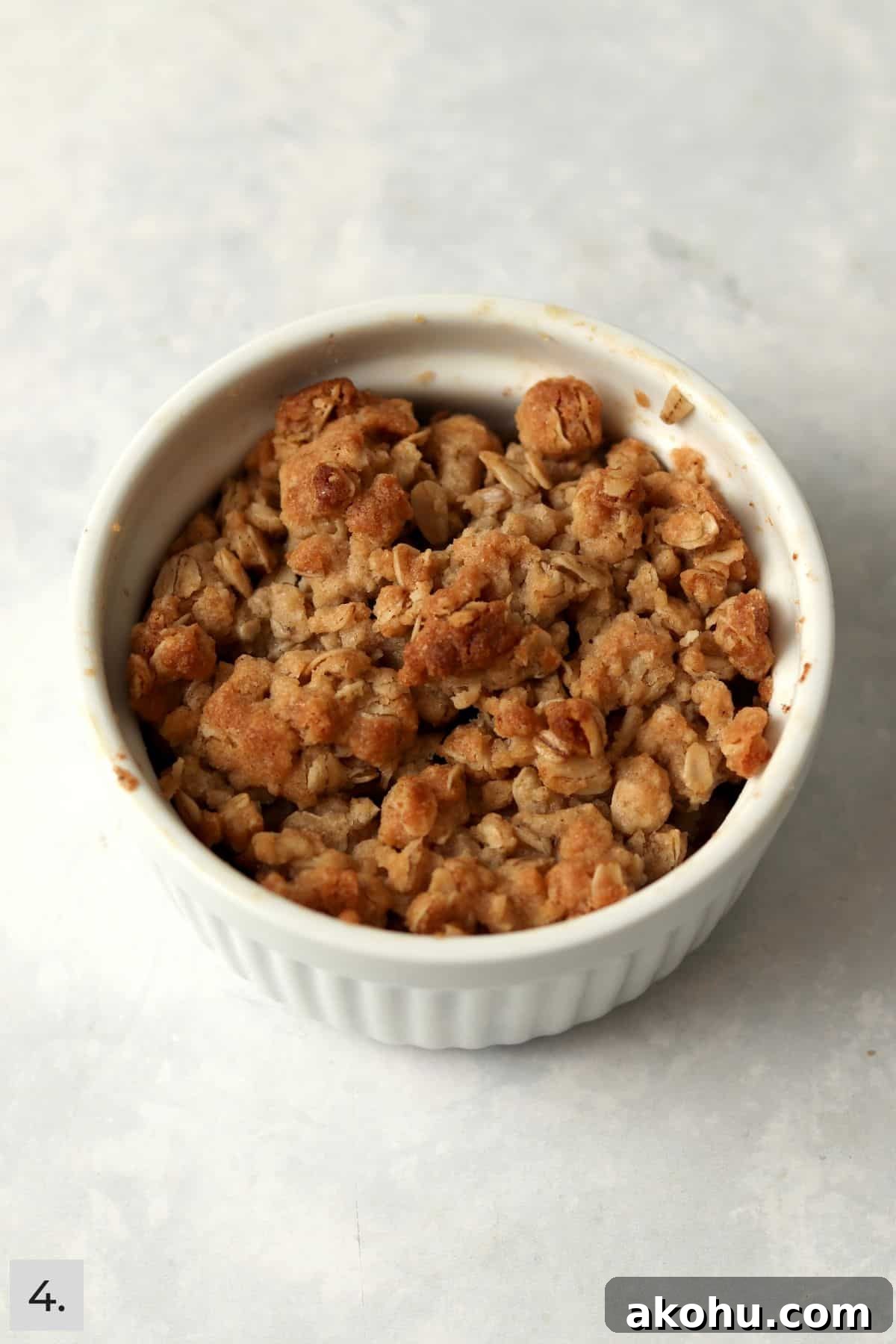 Individual Apple Crisp with Oat Topping — Single-Serve Recipe 7 A baked single serve apple crisp in a ramekin.