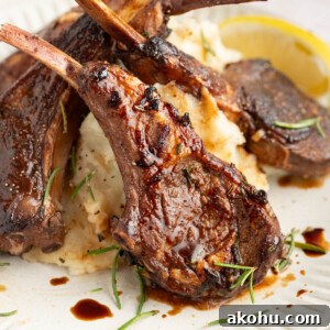 Balsamic-Glazed Oven Roasted Lamb Chops for Dinner 11 Three baked lamb chops on a plate with mashed potatoes.