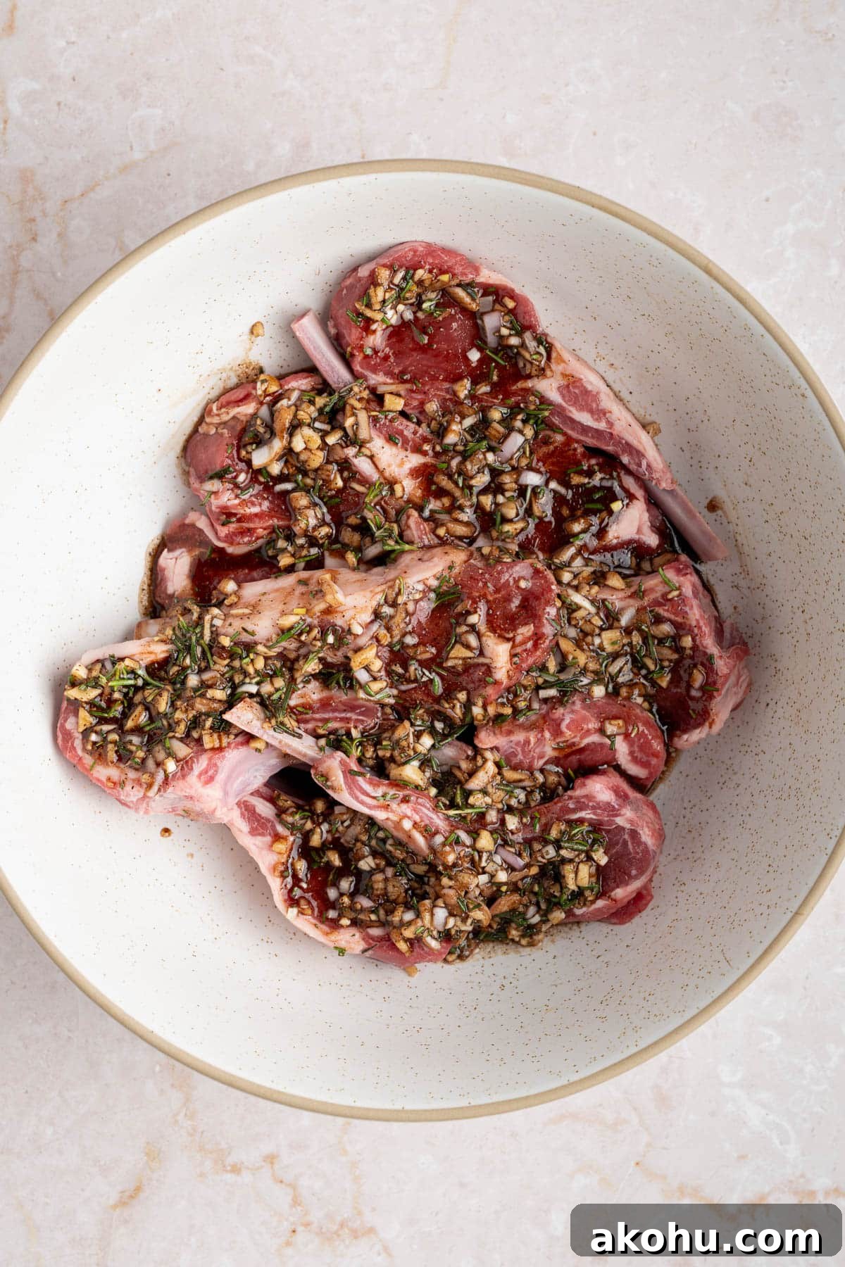Balsamic-Glazed Oven Roasted Lamb Chops for Dinner 4 The lamb chops marinating in the bowl covered in the marinade.