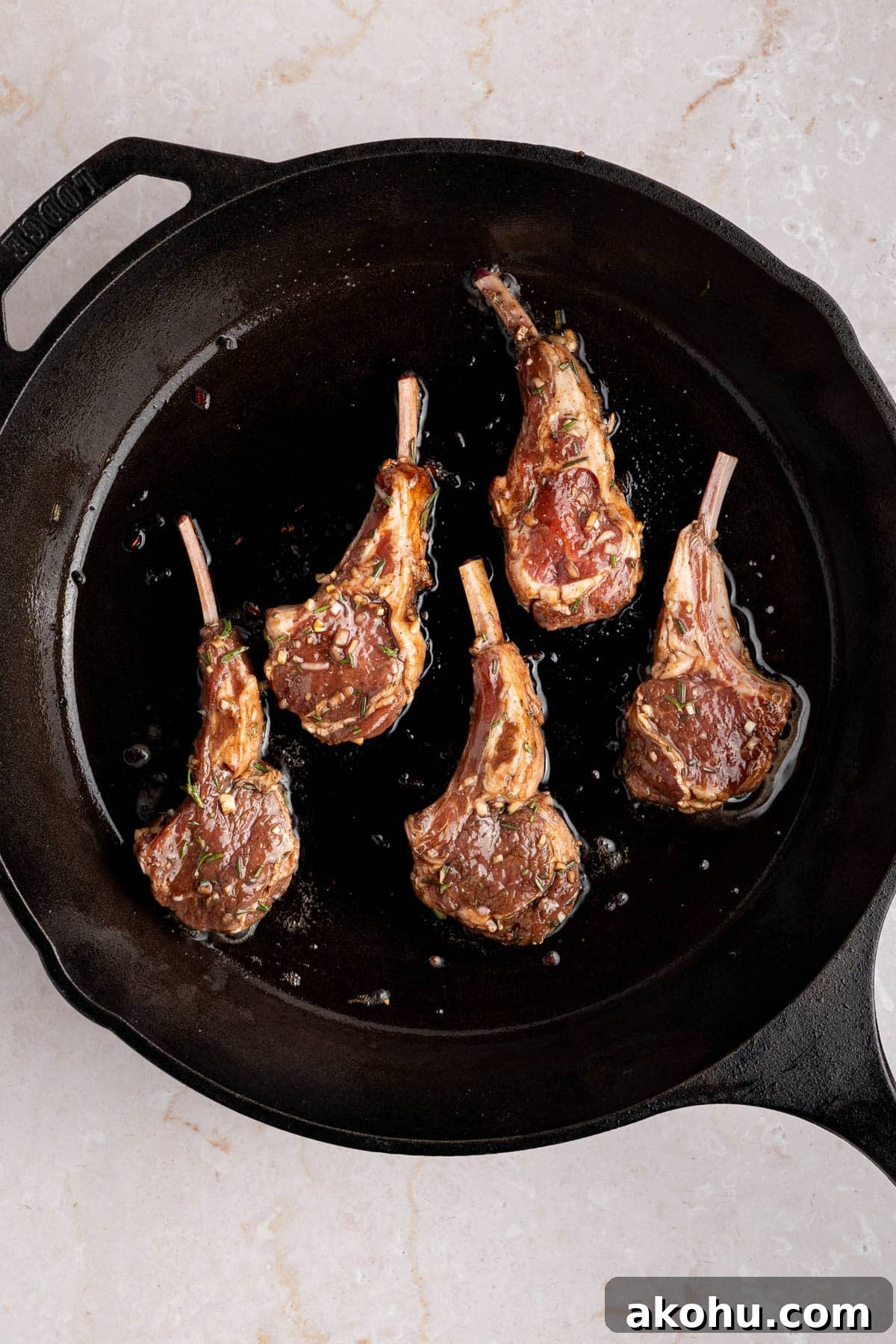 Balsamic-Glazed Oven Roasted Lamb Chops for Dinner 5 The lamb chops searing in a hot cast iron pan.
