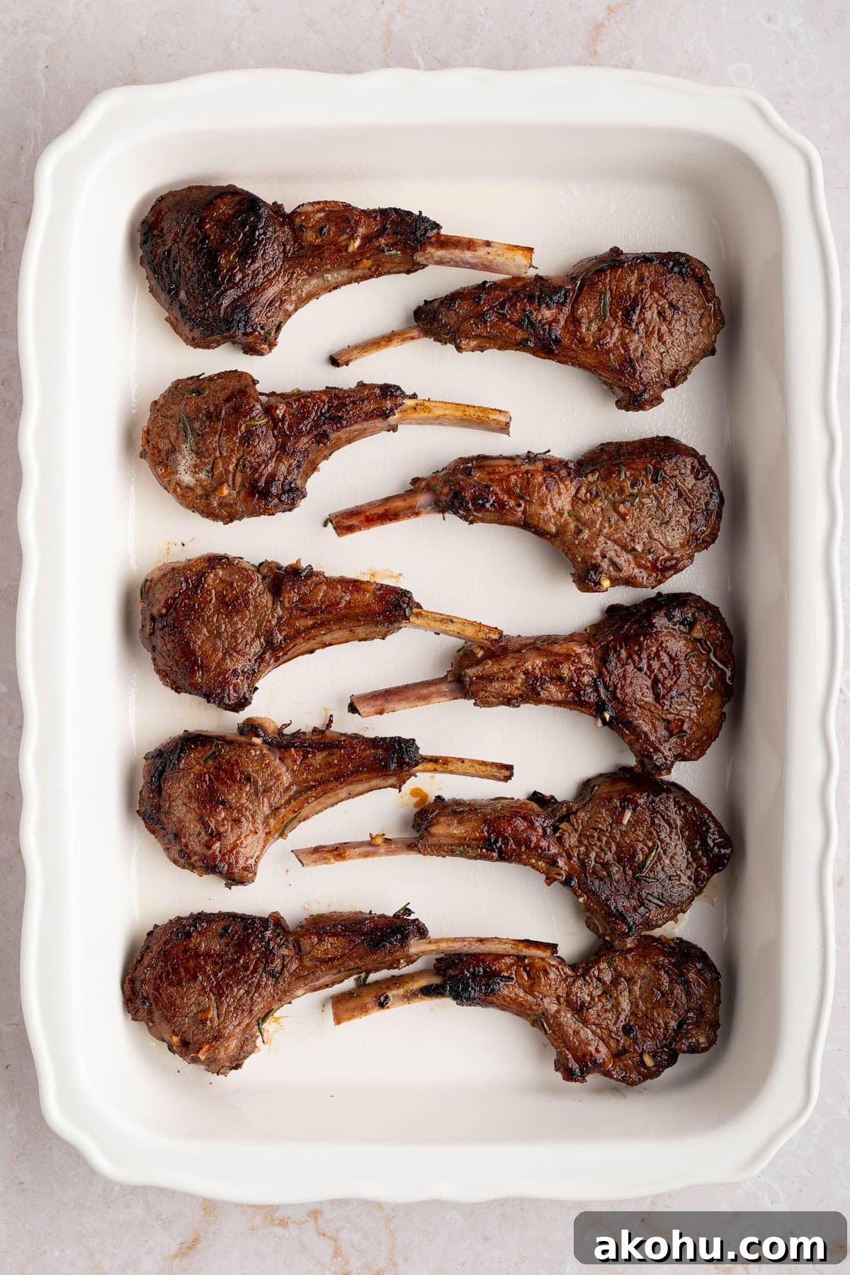 Balsamic-Glazed Oven Roasted Lamb Chops for Dinner 6 The seared lamb chops in a white baking dish before baking.