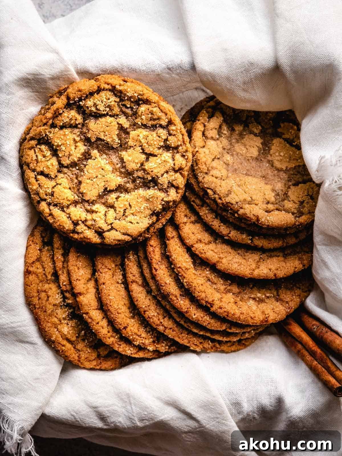 brown sugar cookies in a box with a white cloth and cinnamon sticks