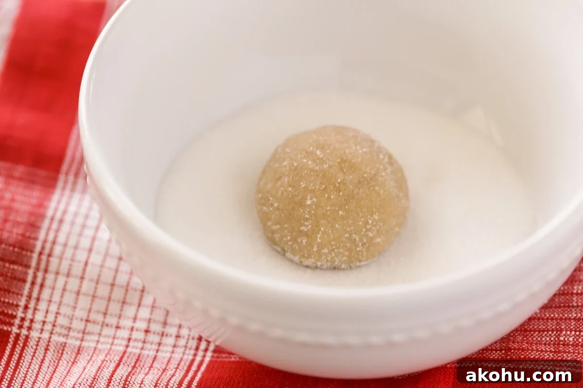 Brown sugar cookies are sweet, soft, and ultra chewy. They are a TASTY twist on a much-loved classic cookie. Brown sugar cookie ingredients formed in a ball, set in a white bowl filled with sugar