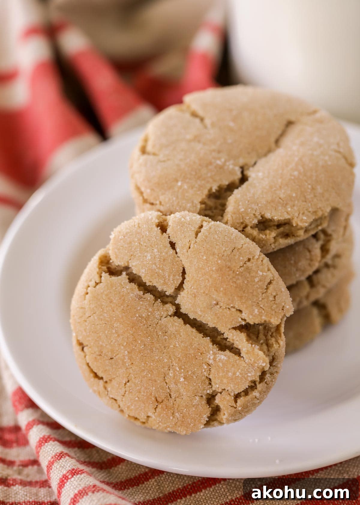 Chewy brown sugar cookies stacked on a white plate