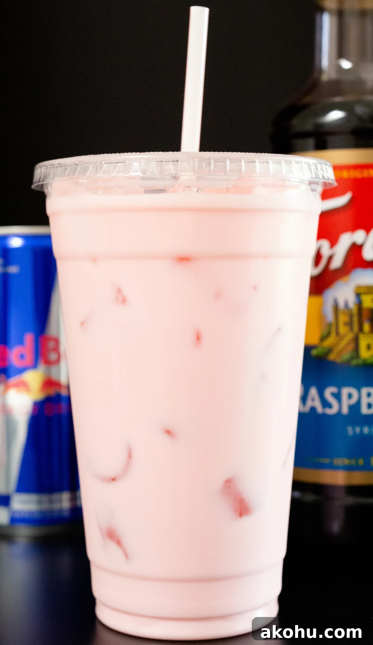 How to Make Sparkling Red Bull Italian Soda at Home 3 A large plastic cup is filled with a pink Red Bull Italian Soda.