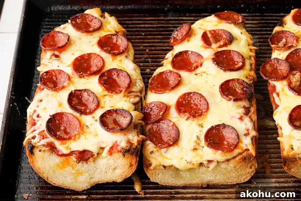Crispy French Bread Pizza Recipe: Quick Weeknight Dinner 2 garlic bread pizza with pepperoni on a baking sheet
