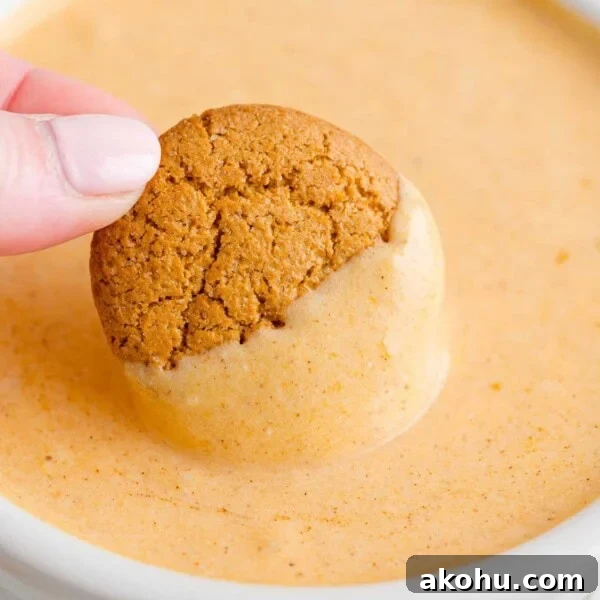 10-Minute Tiramisu Dip: Creamy Espresso Mascarpone Recipe 9 Gingersnap being dipped into creamy pumpkin dip.