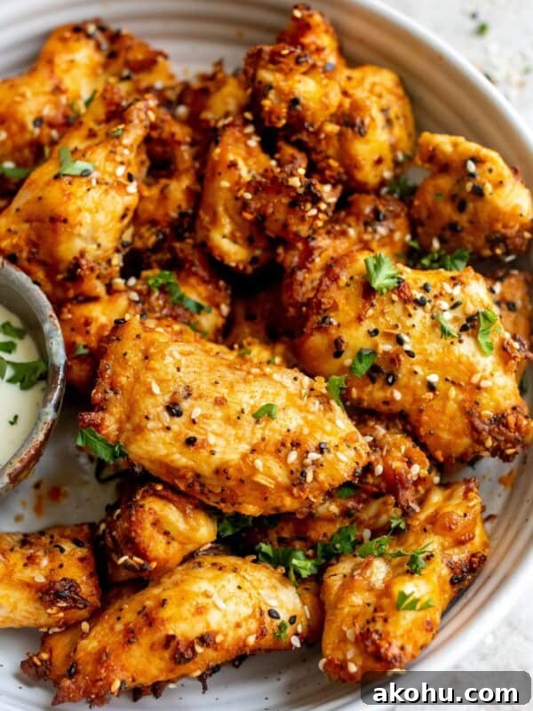 White ceramic bowl with chicken tenders and dipping sauce.