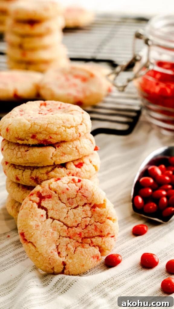 Spicy Red Velvet Cookies: Sweet Heat Recipe 2 Red hot cookies stacked with a scoop of red hot candies next to the stack.