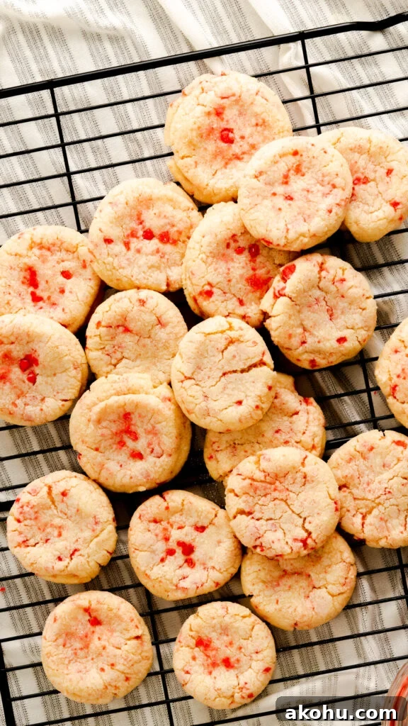 Spicy Red Velvet Cookies: Sweet Heat Recipe 3 Red hot sugar cookies on black wire rack stacked on top of each other.