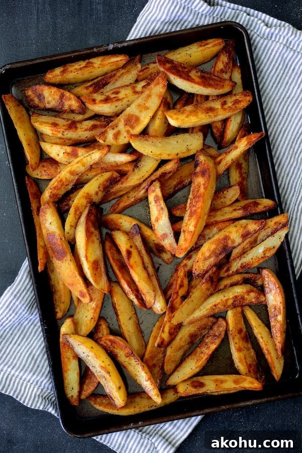 Photo of cooked oven fries on baking sheet.