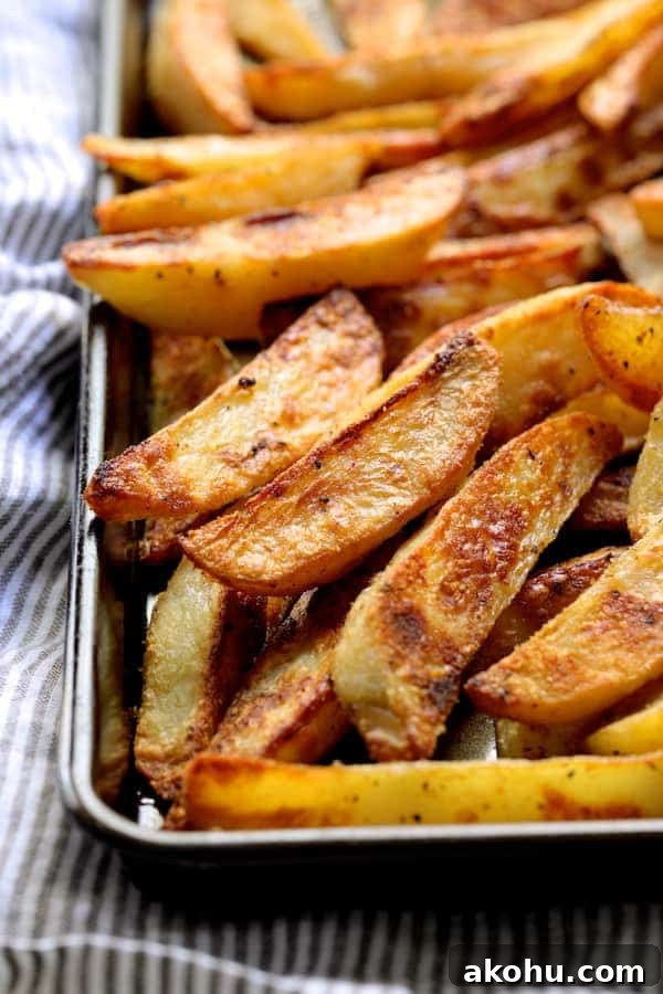 Close-up photo of cooked oven fries on baking sheet.