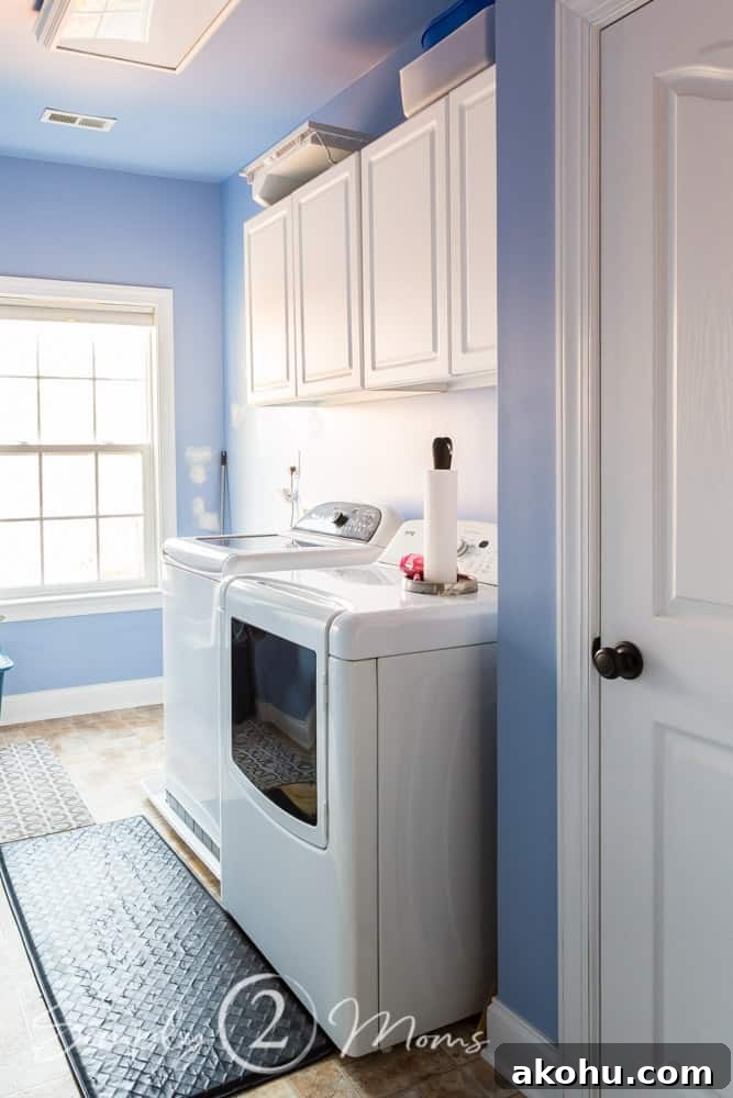 How to Close the Gap Above Kitchen Cabinets for a Finished Look 2 Laundry room with white cabinets with opening above holding cleaning supplies