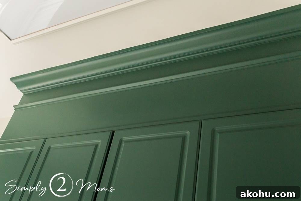 How to Close the Gap Above Kitchen Cabinets for a Finished Look 12 wood box filling in the space above cabinets in a laundry room with crown and neck molding painted Lafayette Green
