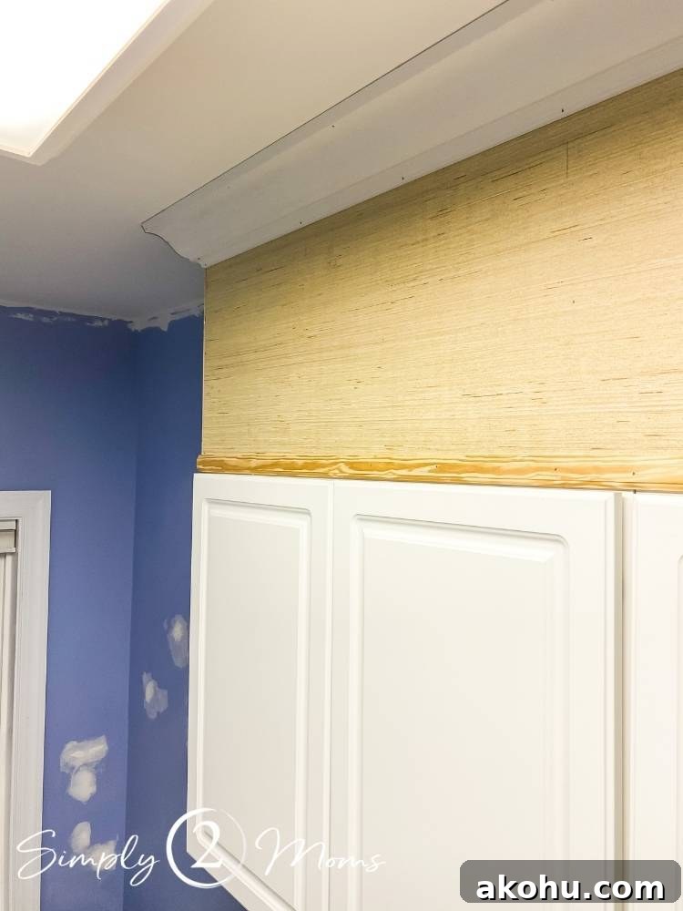 How to Close the Gap Above Kitchen Cabinets for a Finished Look 8 wood box filling in the space above cabinets in a laundry room with crown molding