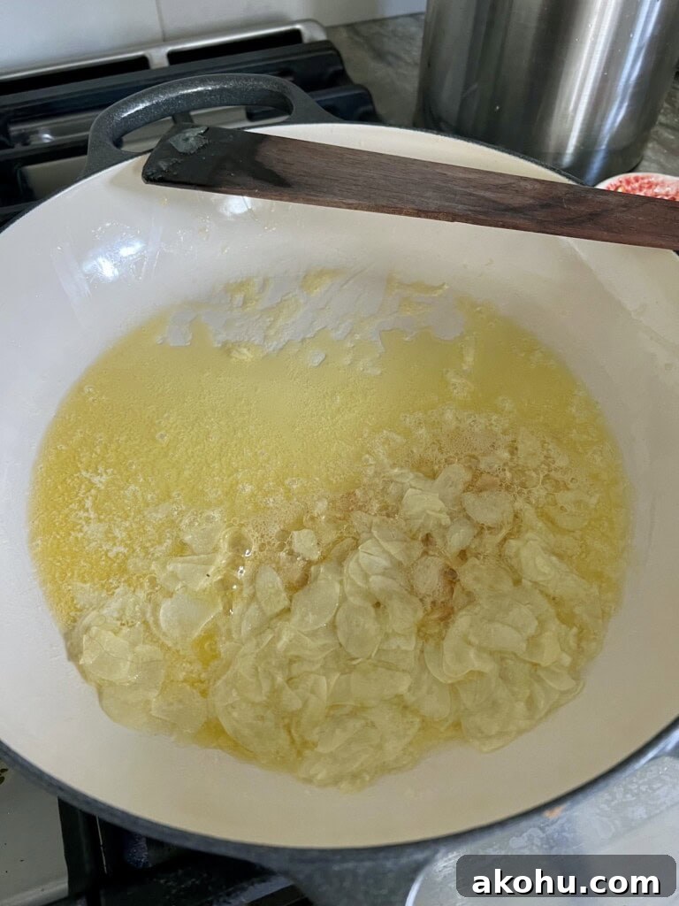 Sautéing garlic in olive and butter for Italian chicken and mushrooms.