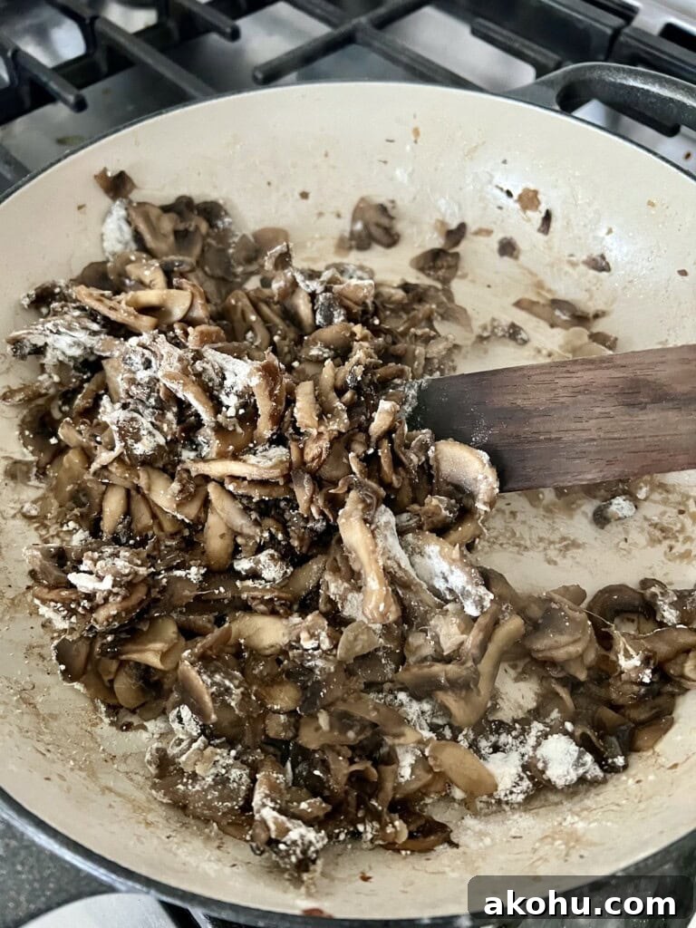 Mixing flour into cooked mushrooms.