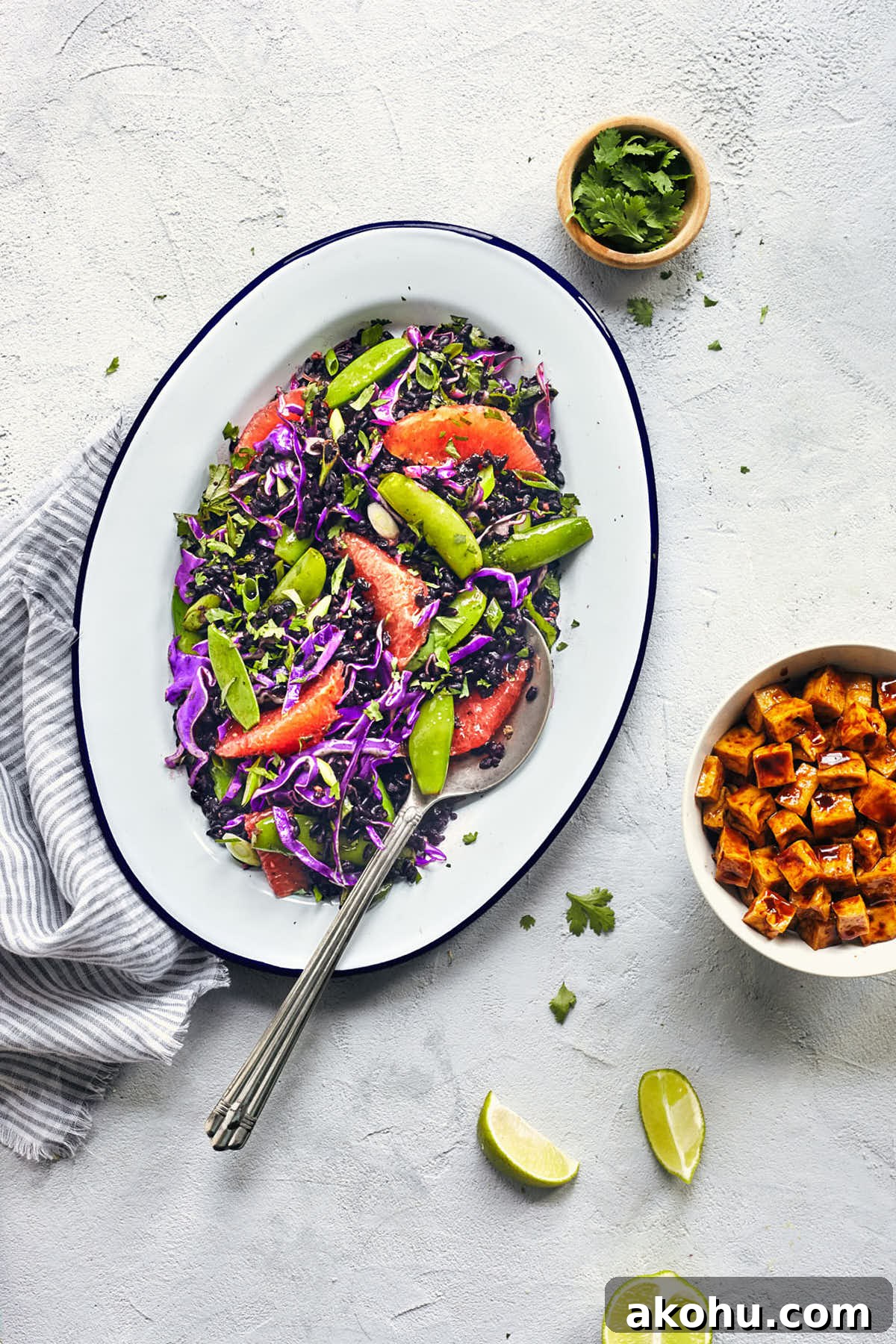 Citrus Ginger Black Rice Salad with Avocado & Mint 4 Serving spoon digging into Asian black rice salad