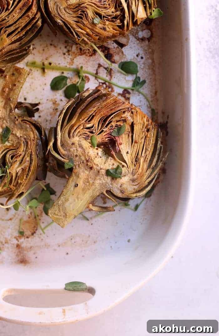 These bright and nutty oven roasted artichokes with dairy-free creamy cashew aioli make the perfect side dish or appetizer. Vegan and gluten-free.