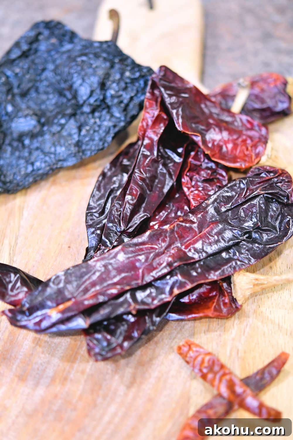 dried ancho, guajillo and chiles de arbol on a cutting board