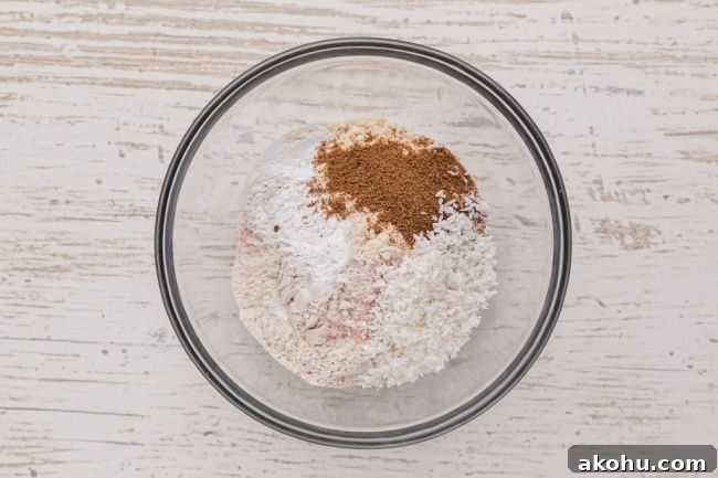 Flour, sugar, coconut, and baking powder in a bowl.